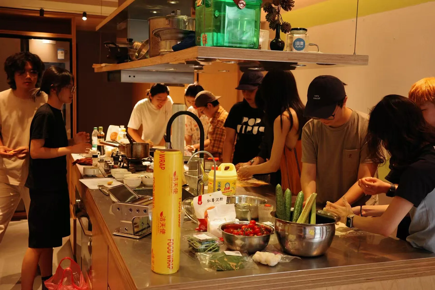 The kitchen with the pasta machine at the left and the group along the counter