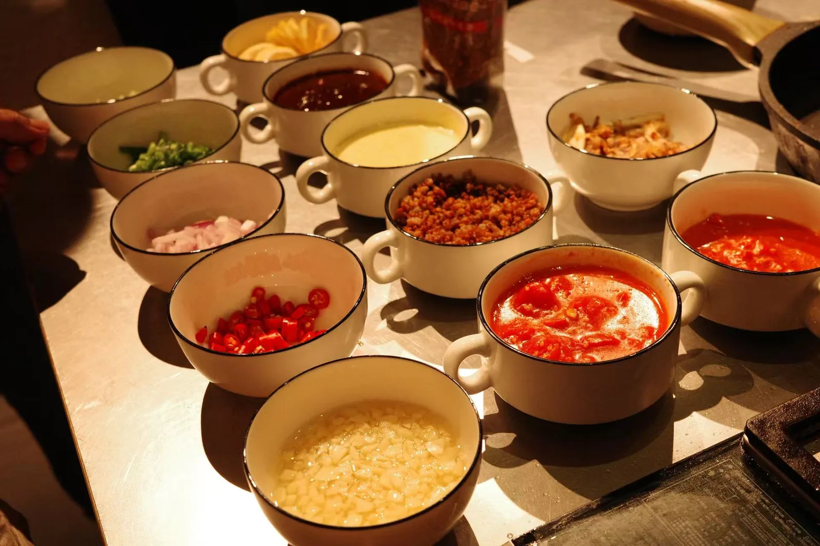 A row of cups for the sauces and toppings