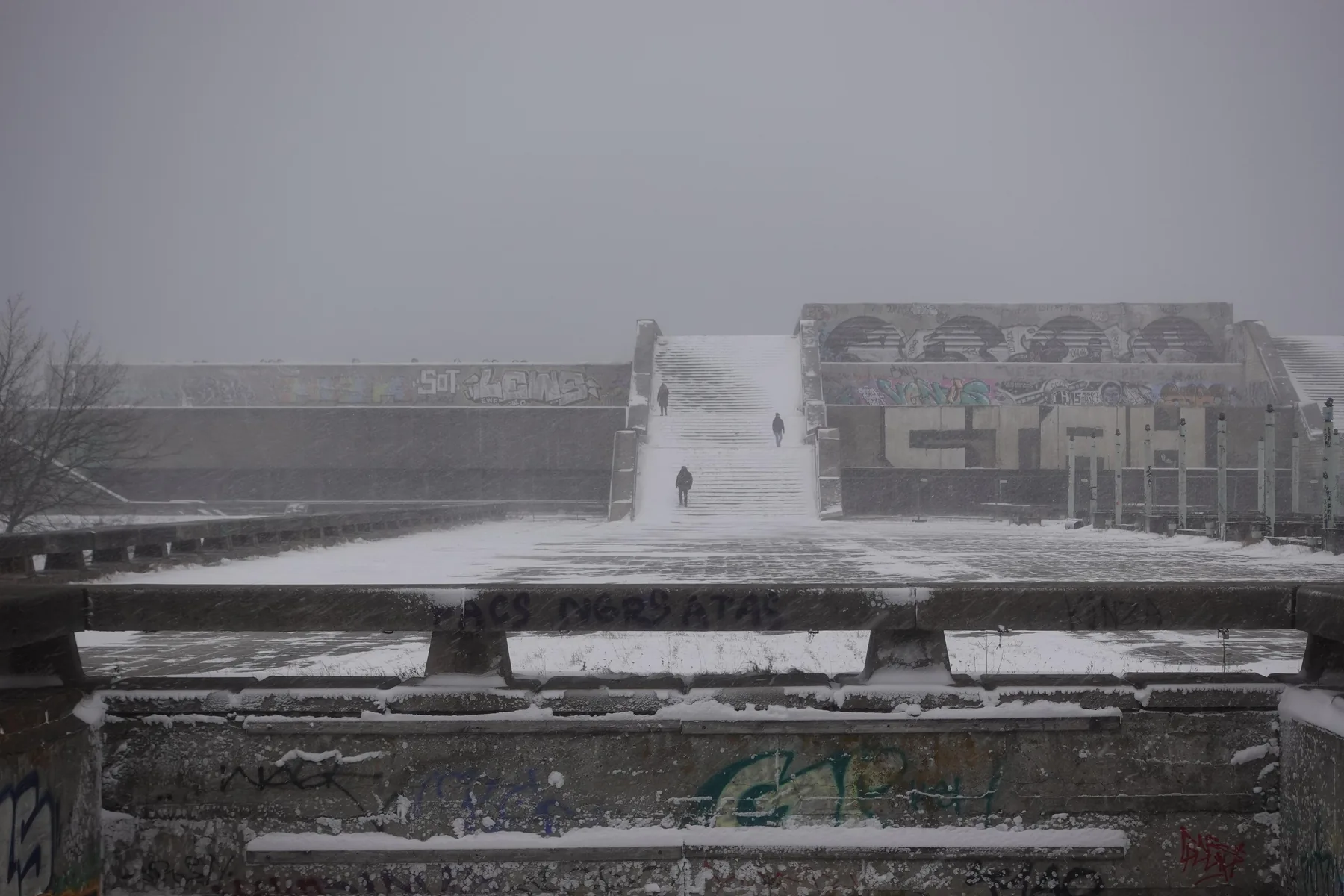 Linnahall in Tallinn under snow: weathered concrete terraces and a long stair